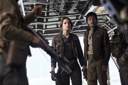 A scene from Rogue One: A Star Wars Story featuring Jyn Erso, portrayed by Felicity Jones, and Diego Luna, set against a backdrop of tense action and adventure.