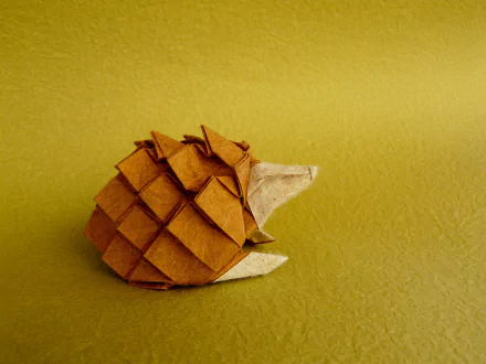 Origami hedgehog crafted from brown paper against a textured yellow background, showcased as an HD PC desktop wallpaper and background.