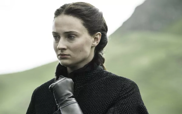 Sophie Turner as Sansa Stark in Game of Thrones, captured in a detailed 4K Ultra HD desktop wallpaper with a moody, natural landscape background.