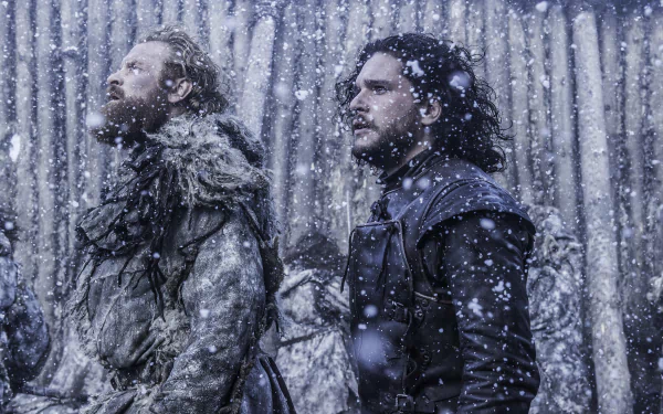 Tormund Giantsbane and Jon Snow stand amidst falling snow in this stunning 4K Ultra HD wallpaper from the TV show Game of Thrones, capturing a moment of camaraderie.