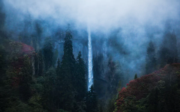 4K Ultra HD PC desktop wallpaper: fog-wrapped waterfall cascading down a steep Turkish cliff through dark evergreens and rust-colored foliage.