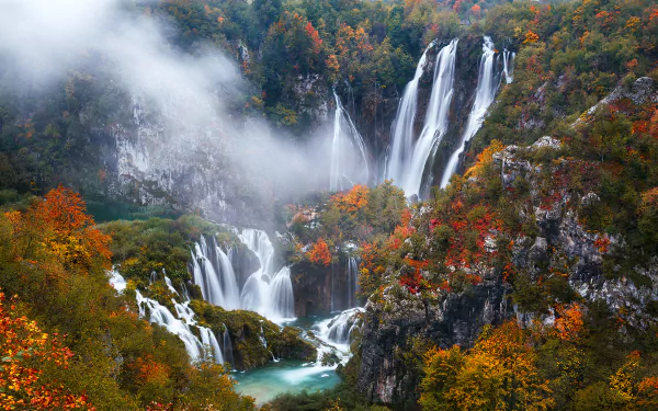 Autumn view of cascading waterfalls and turquoise pools at Plitvice Lakes National Park, vibrant fall foliage and mist — HD desktop wallpaper.