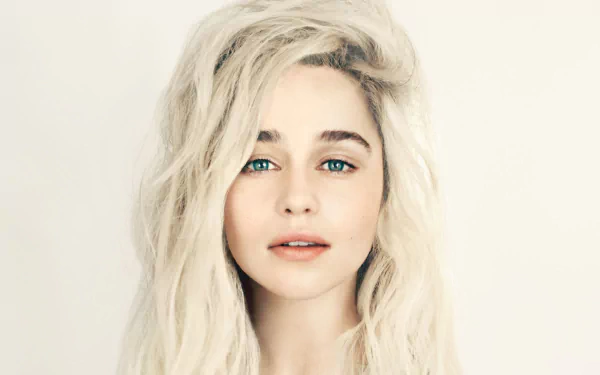 Close-up of Emilia Clarke, an English actress with striking green eyes and blonde hair, presented as a high-definition desktop wallpaper.
