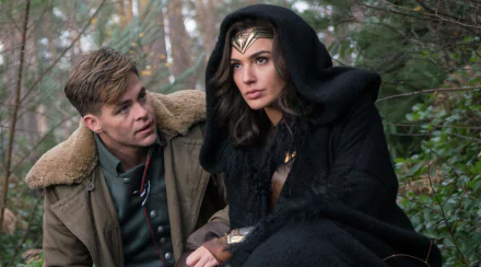 HD desktop wallpaper featuring Gal Gadot and Chris Pine in a scene from the movie Wonder Woman. Gadot is dressed as Wonder Woman with her iconic tiara, and Pine is alongside her in a green jacket.