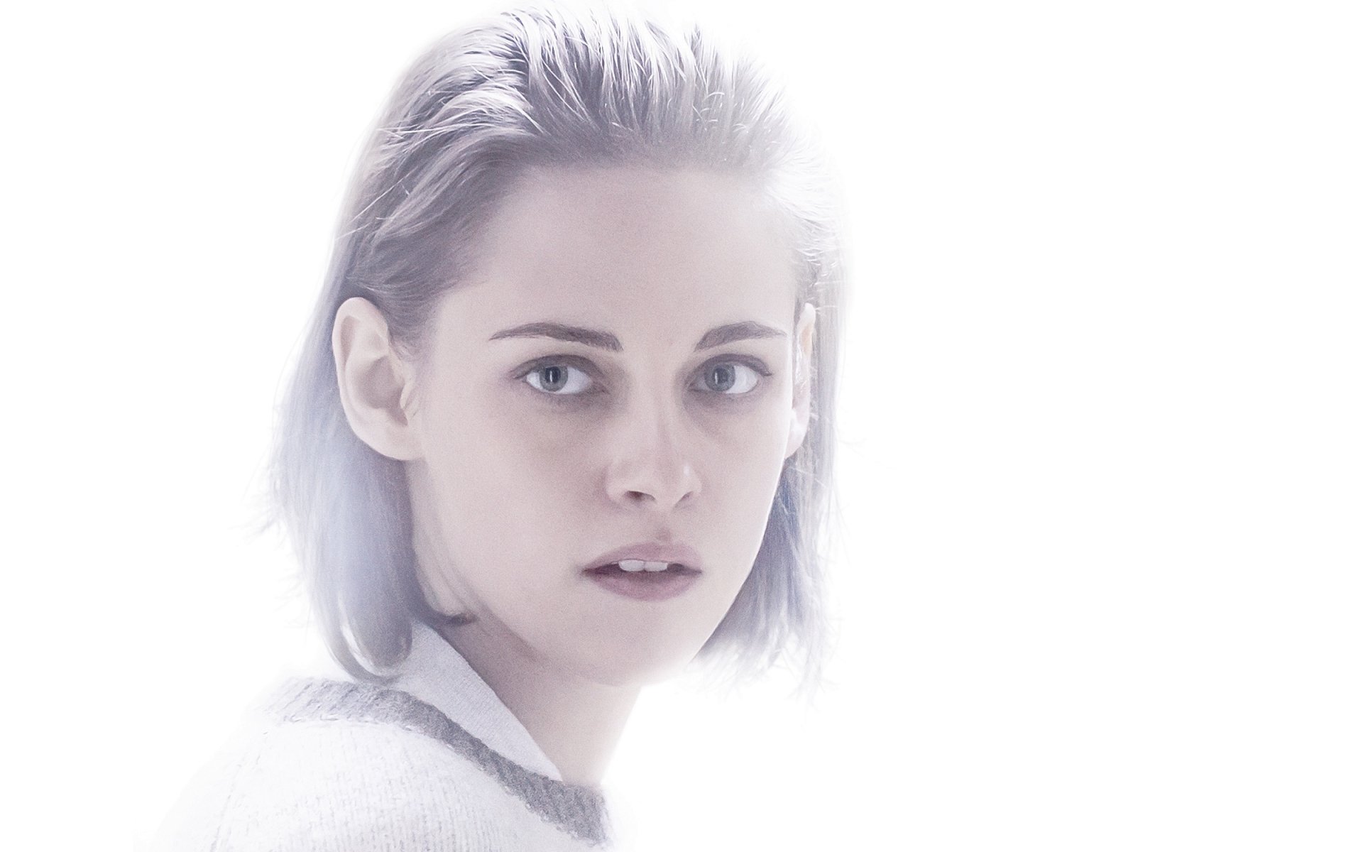 HD desktop wallpaper featuring Kristen Stewart from the movie Personal Shopper, with a soft, ethereal white background highlighting her intense gaze.