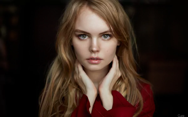 A high-definition desktop wallpaper featuring a blonde-haired, green-eyed Russian model with a serene expression. The image highlights her natural beauty.