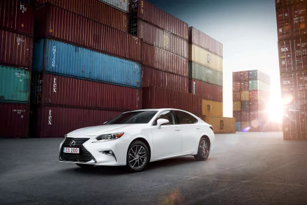 4K Ultra HD PC desktop wallpaper of a white Lexus ES sedan parked in a shipping container yard at sunset, sleek Lexus vehicle on concrete.