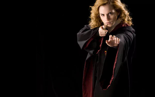 Hermione Granger, portrayed by Emma Watson, casts a spell in this HD Harry Potter wallpaper, capturing her magical presence against a dark background.