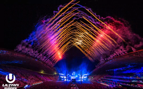 Vibrant Ultra Music Festival night scene with colorful laser lights and fireworks illuminating a massive crowd, captured in an HD PC desktop wallpaper background.