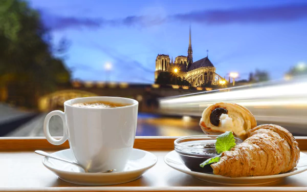 4K Ultra HD desktop wallpaper featuring a time-lapse view of Sacré-Cœur with a breakfast scene of coffee, croissant, and jam in the foreground.