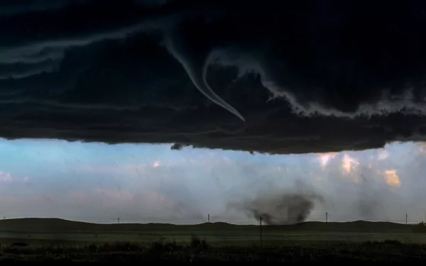 HD PC desktop wallpaper capturing a dramatic nature landscape with dark storm clouds and a twisting tornado under a moody sky.