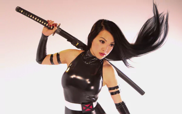 High-definition wallpaper featuring a woman in a striking Psylocke cosplay by Linda Le, wielding a katana with dynamic hair movement and a sleek, black outfit.