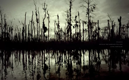 A dark, moody landscape featuring skeletal trees reflecting in still water, serving as a striking HD desktop wallpaper inspired by Nine Inch Nails' aesthetic.