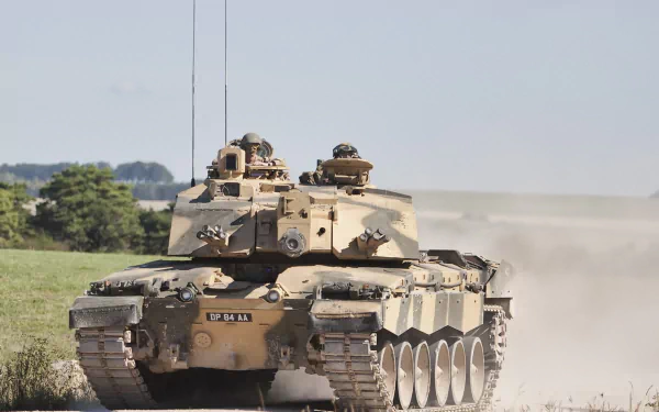 HD PC desktop wallpaper featuring a Challenger 2 military tank advancing through a dry, open terrain under a clear sky.