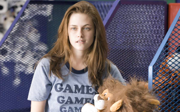 HD desktop wallpaper featuring Kristen Stewart from the movie Adventureland, with her wearing a Games t-shirt and holding a stuffed lion.
