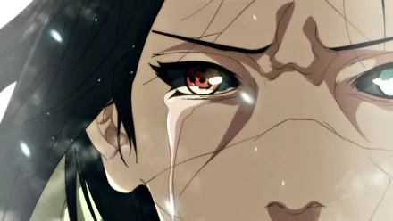 Close-up of a character from the anime Naruto, displaying intense emotion with tears and vibrant red eyes, set against a soft, blurred background. High-definition desktop wallpaper.