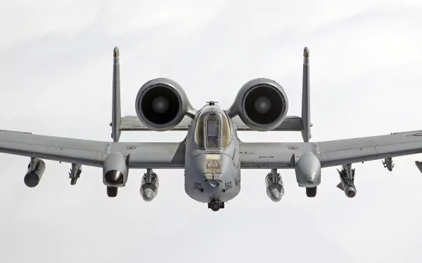 A striking HD desktop wallpaper featuring the Fairchild Republic A-10 Thunderbolt II, a formidable military jet fighter soaring through a cloudy sky.