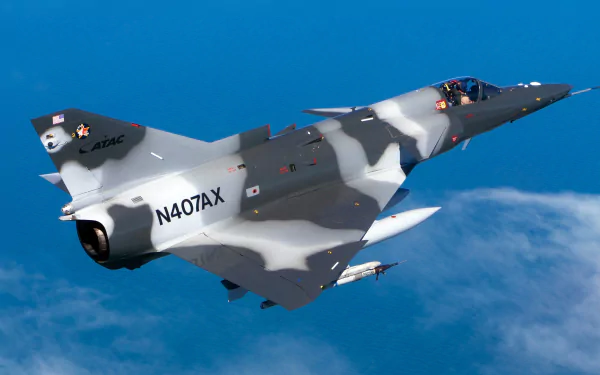 An IAI Kfir jet fighter soaring through the sky, showcasing its military design. This HD wallpaper captures the sleek contours and camouflage of the aircraft against a blue backdrop.