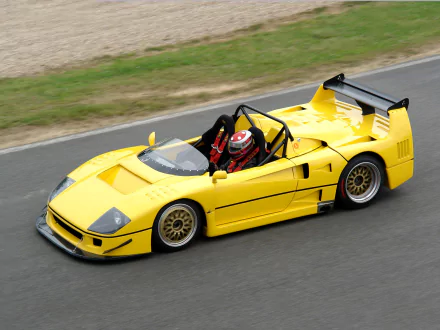 Yellow Ferrari F40 LM Barchetta supercar race car speeding on a track, captured in high-definition for a dynamic PC desktop wallpaper background.