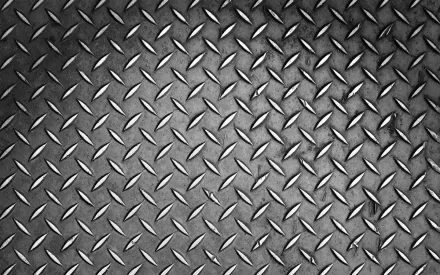 HD desktop wallpaper featuring an abstract metal pattern with a textured diamond plate design in a monochromatic, industrial style.