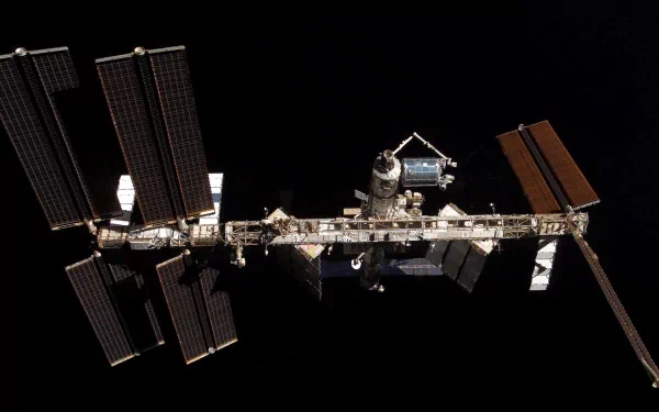 A stunning view of the International Space Station, a man-made satellite, captured by NASA against the backdrop of space, showcasing intricate structures and solar panels.