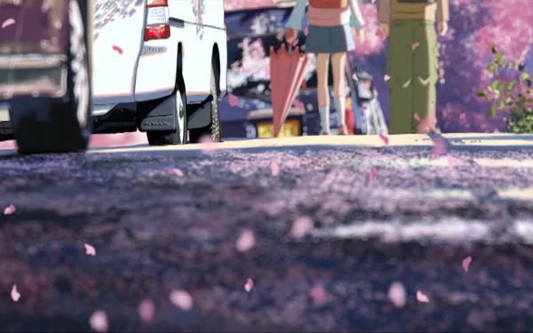 HD anime desktop wallpaper from 5 Centimeters per Second, featuring a close-up view of a cherry blossom-lined street with petals scattered on the ground and two characters walking.
