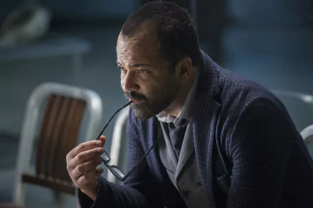 A contemplative Bernard Lowe, played by Jeffrey Wright, holds his glasses while deep in thought, captured in a scene from the TV show Westworld. A striking HD desktop wallpaper.