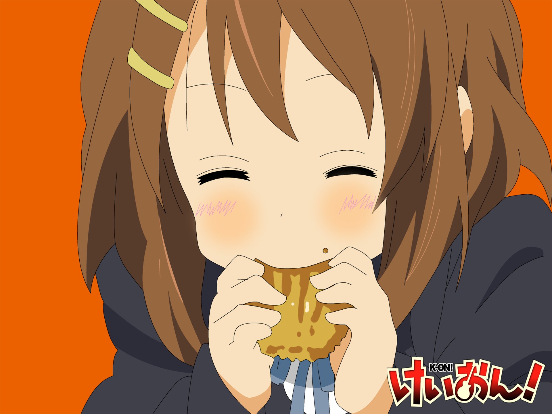 HD PC desktop wallpaper of Yui Hirasawa from K-ON! smiling with closed eyes while munching a cookie against a bright orange background.