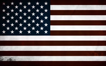 A high-definition desktop wallpaper featuring a man-made American flag, showcasing the stars and stripes in bold, vivid colors against a textured background.