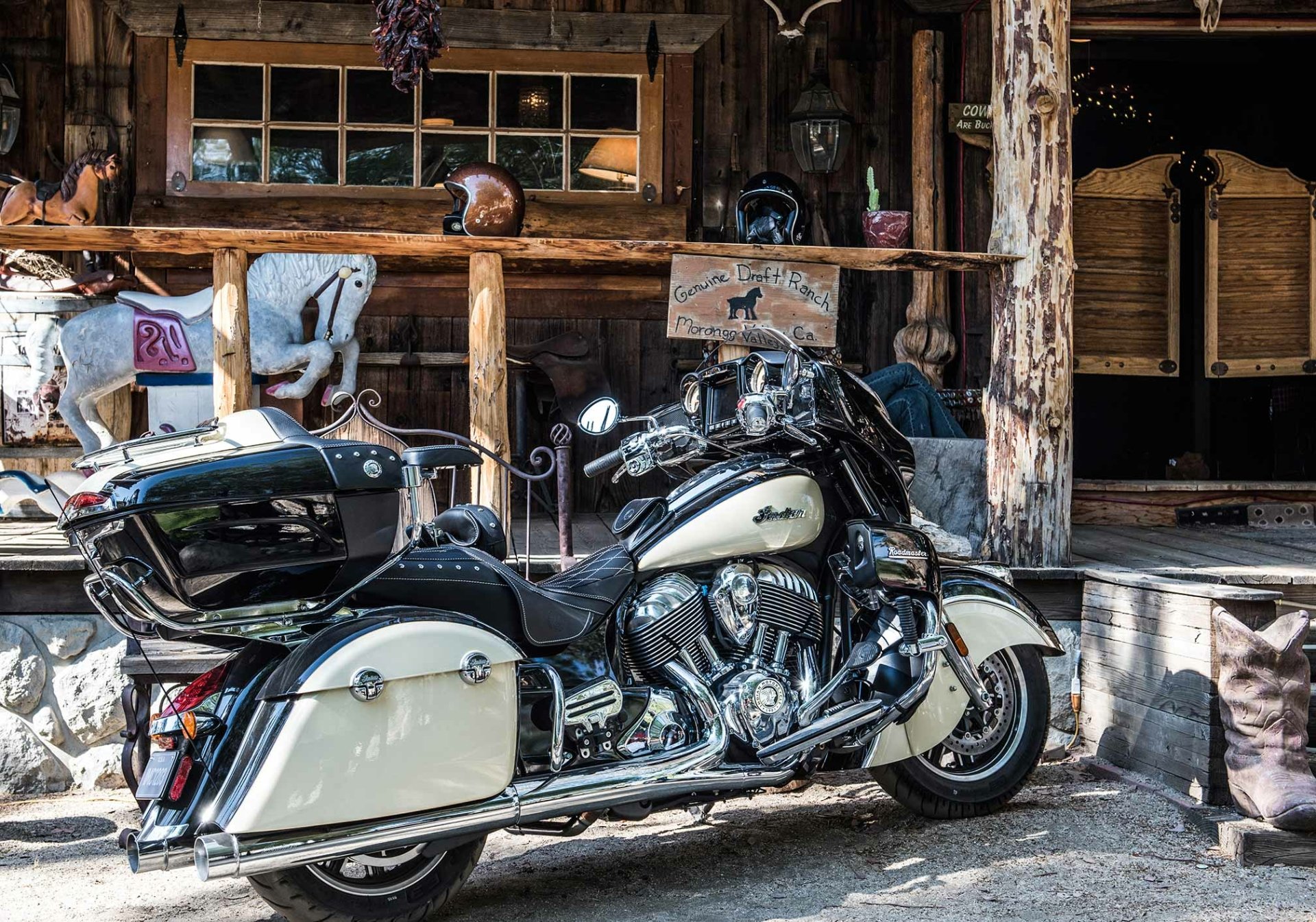 HD PC desktop wallpaper and background, vehicle: a cream-and-black Indian Roadmaster touring motorcycle parked before a rustic wooden storefront, chrome gleaming.