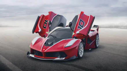 HD PC desktop wallpaper featuring a red Ferrari FXX K with its scissor doors open on an empty, overcast road.