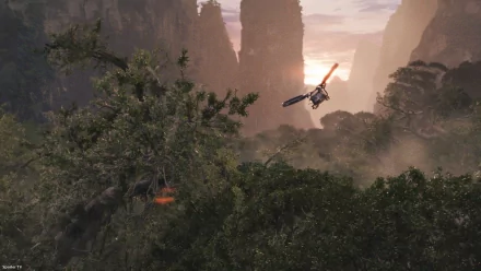 HD desktop wallpaper from the movie Avatar featuring a helicopter soaring over a lush forest with towering mountains in the background. The sunset casts a warm glow over the serene natural landscape.