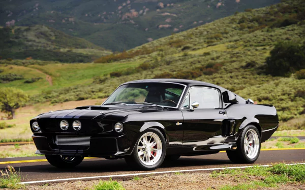 A sleek black hot rod parked on a road with green hills in the background, captured in high-definition as a PC desktop wallpaper and background.