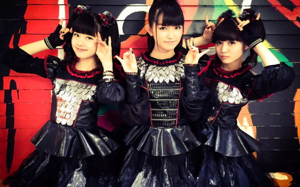 HD PC wallpaper featuring the Japanese metal idol group Babymetal in heavy metal attire against a vibrant graffiti backdrop.