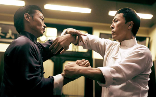 4K Ultra HD PC desktop wallpaper from the movie Ip Man 3 showing two martial artists practicing Wing Chun, gripping each other's arms in a dim training room.