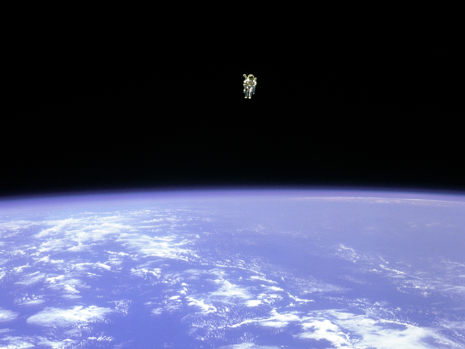 Astronaut floating in outer space against a beautiful background.