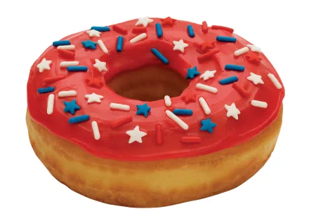 HD desktop wallpaper of a doughnut with red icing topped with blue, white, and red star and sprinkle decorations, showcasing a festive and colorful food design.