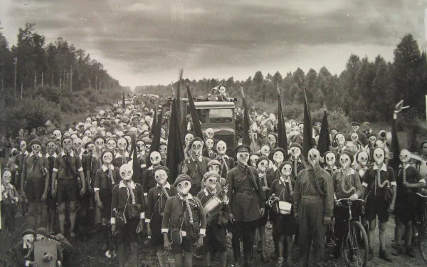 HD PC desktop wallpaper depicting a large group of people wearing gas masks in a military-style formation outdoors under a cloudy sky.
