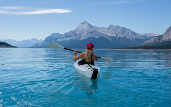  Woman paddling in a beautiful blue lake