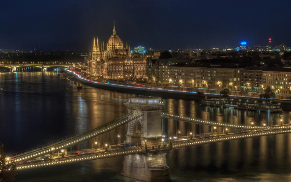 HD desktop wallpaper: Night view of Budapest, Hungary — illuminated Chain Bridge and Hungarian Parliament Building along the Danube river, city skyline and man-made landmarks.