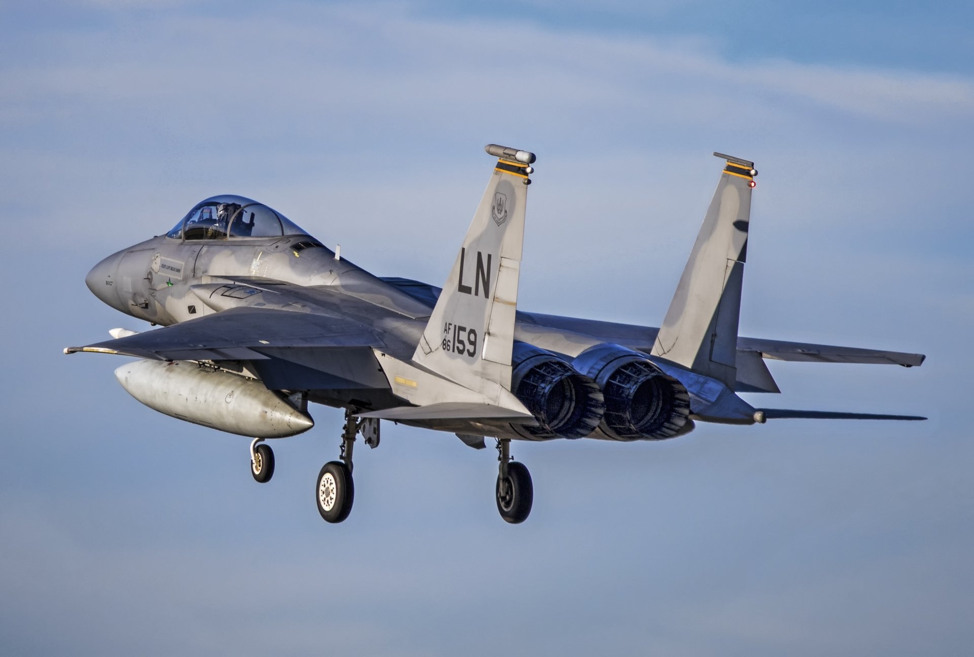 McDonnell Douglas F-15 Eagle jet fighter warplane in flight against a clear blue sky, captured in striking detail for a 4K Ultra HD military aircraft wallpaper.