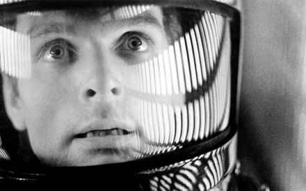 Close-up of an astronaut’s face reflected in a helmet visor from the movie 2001: A Space Odyssey, presented as an HD PC desktop wallpaper and background.