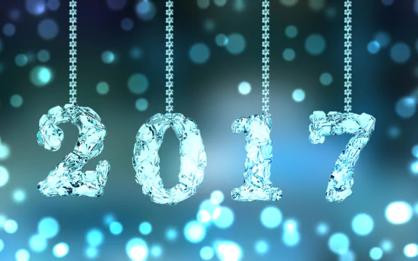 HD desktop wallpaper featuring a light blue festive background with 2017 hanging from beaded strings, celebrating New Year 2017.
