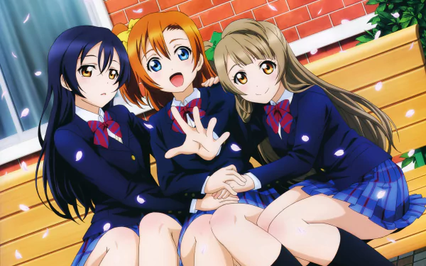 HD desktop wallpaper featuring Umi Sonoda, Honoka Kousaka, and Kotori Minami from the anime Love Live!, sitting on a bench in school uniforms, surrounded by falling cherry blossoms.