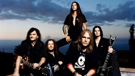 HD desktop wallpaper featuring the heavy metal band Helloween. Five members of the band with guitars pose against a dramatic evening sky backdrop.