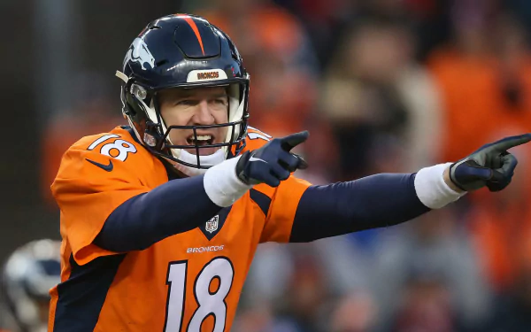 HD desktop wallpaper of a football player in an orange jersey, mid-action during a game, functioning as a dynamic background.