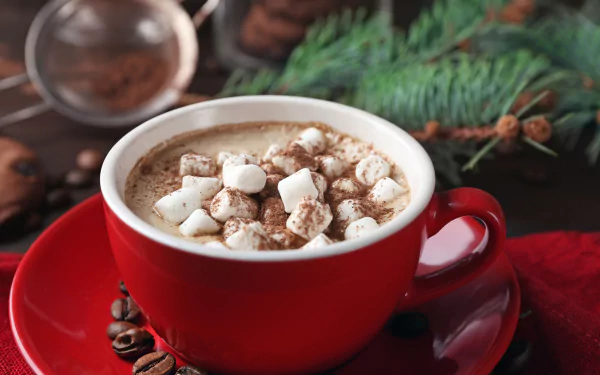 A red cup filled with hot chocolate topped with marshmallows, surrounded by coffee beans and pine branches, captured in 4K Ultra HD for a PC desktop wallpaper.