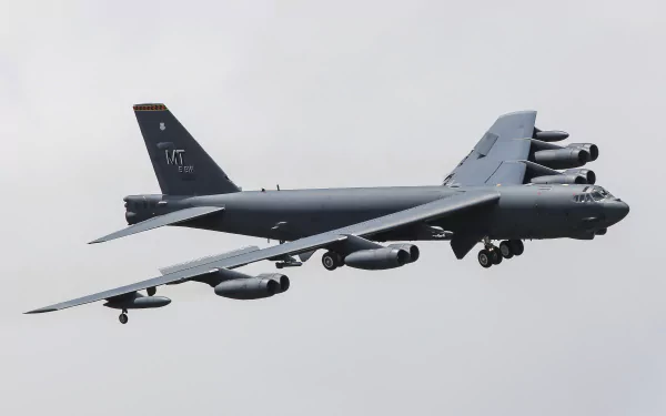 A Boeing B-52 Stratofortress military bomber aircraft of the air force in flight against a cloudy sky, captured in 4K Ultra HD detail.