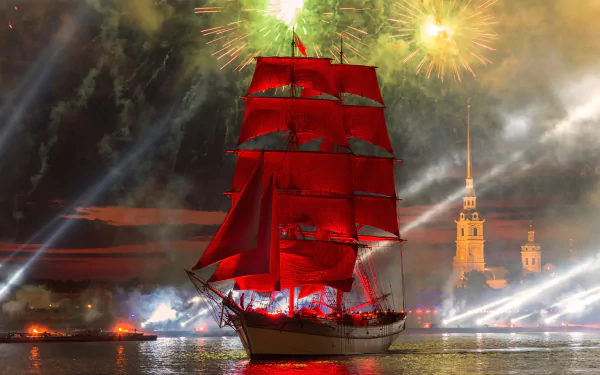 A tall ship with vibrant red sails glides on the river in Saint Petersburg, Russia, illuminated by colorful fireworks against a night sky.