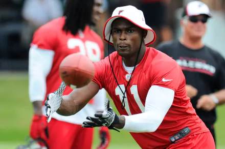 HD wallpaper featuring Julio Jones in a red football uniform focusing intently during practice.